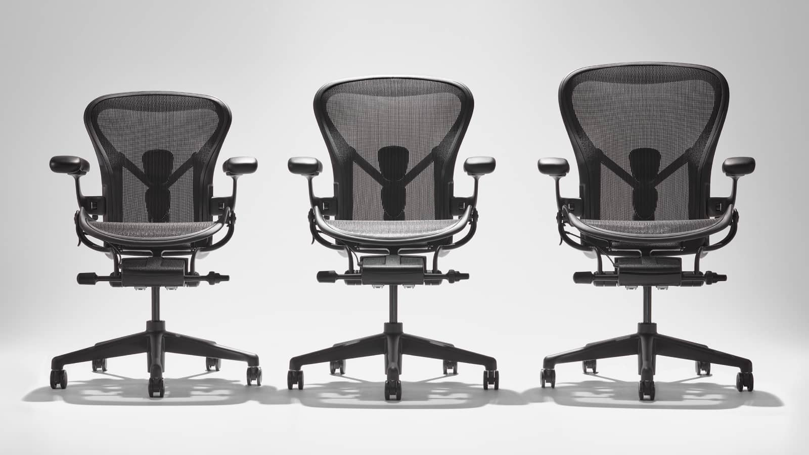 Three Aeron chairs in ascending size order A, B, C.