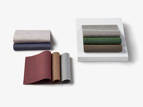 Three stacks of folded samples representing the Hint fabric family.
