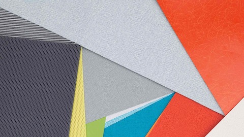 Layers of multi-colored fabric and material swatches showing the various textures, finishes and materials available.