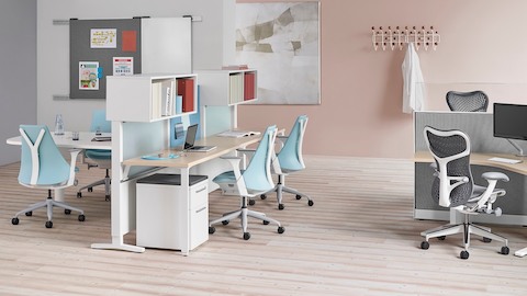 An open healthcare administrative area featuring light blue Sayl Chairs and gray Mirra 2 Chairs. Select to go to the Healthcare solutions page.