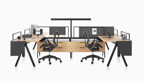 Brown and black Canvas Vista workstations with a-shaped legs, modesty screens, t-shaped light, and black Cosm chairs.