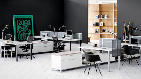 White Canvas Storage units delineate space and provide guest seating in an open office.