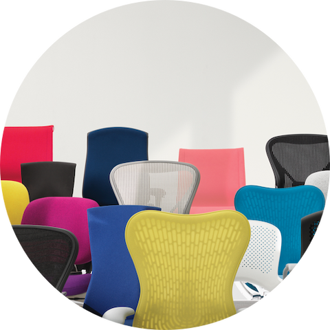 A variety Herman Miller work chairs in different colors grouped together.