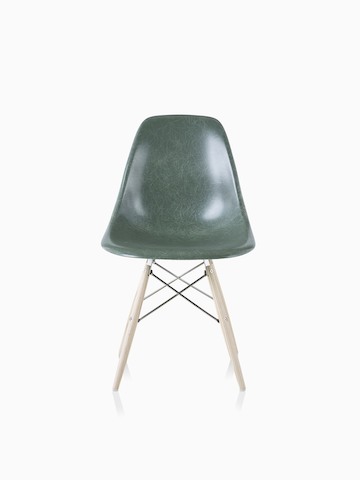 An Eames Molded Fiberglass Side Chair with a dowel base and dark green seat.