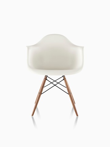 White Eames Molded Plastic armchair with dowel legs, viewed from the front.