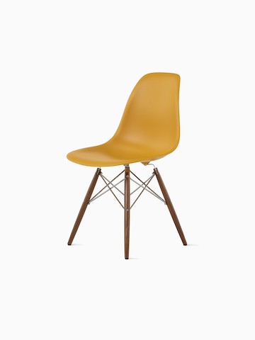 Three-quarter rear view of a black Eames Molded Plastic side chair with dowel legs.