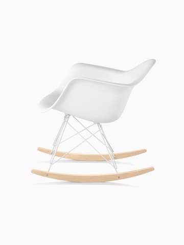 White Eames Molded Plastic rocking chair, viewed from the side.