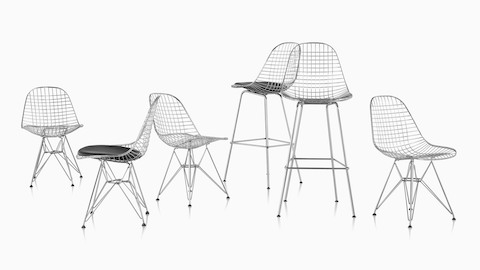 Two Eames Wire stools and four Eames Wire chairs with a mix of seat options.