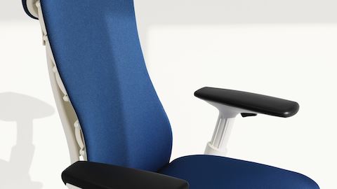 Arm-height control on an Embody Chair  with blue upholstery and a white frame.