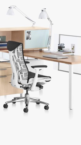 A Canvas Office Landscape workstation with a black Embody office chair. Select to go to the workspaces landing page. 