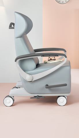 A light gray patient recliner, viewed from the side.