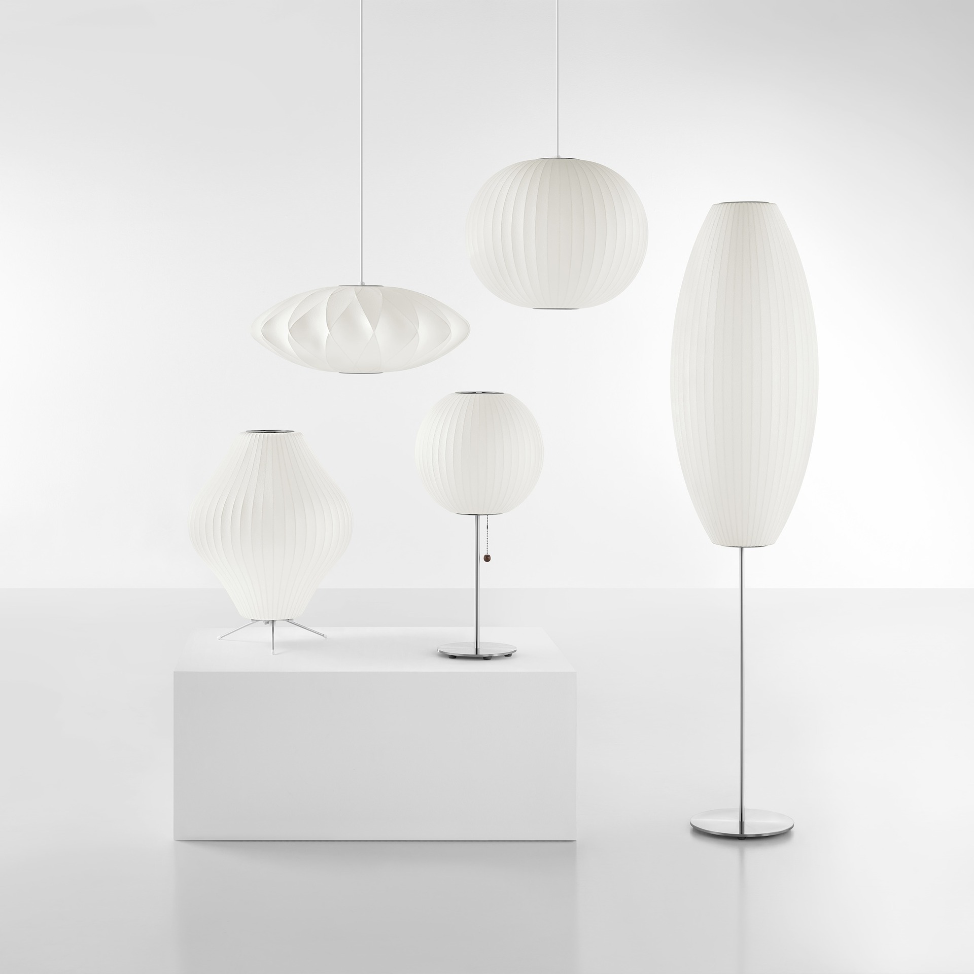 A family shot of Nelson Bubble Lamps, including two pendants, a table, a tripod, and a floor lamp.