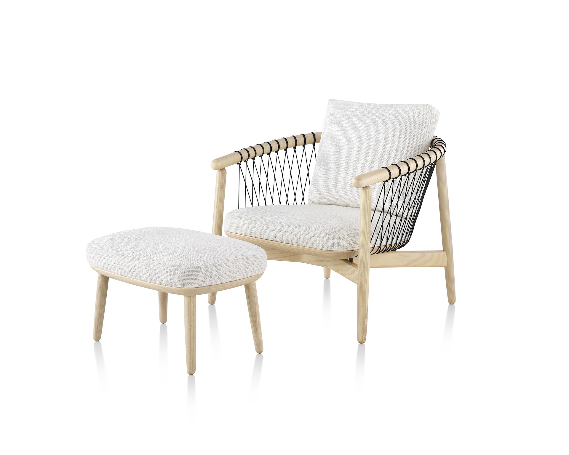 Angled view of a Crosshatch lounge chair and ottoman with off-white fabric and a light wood frame.