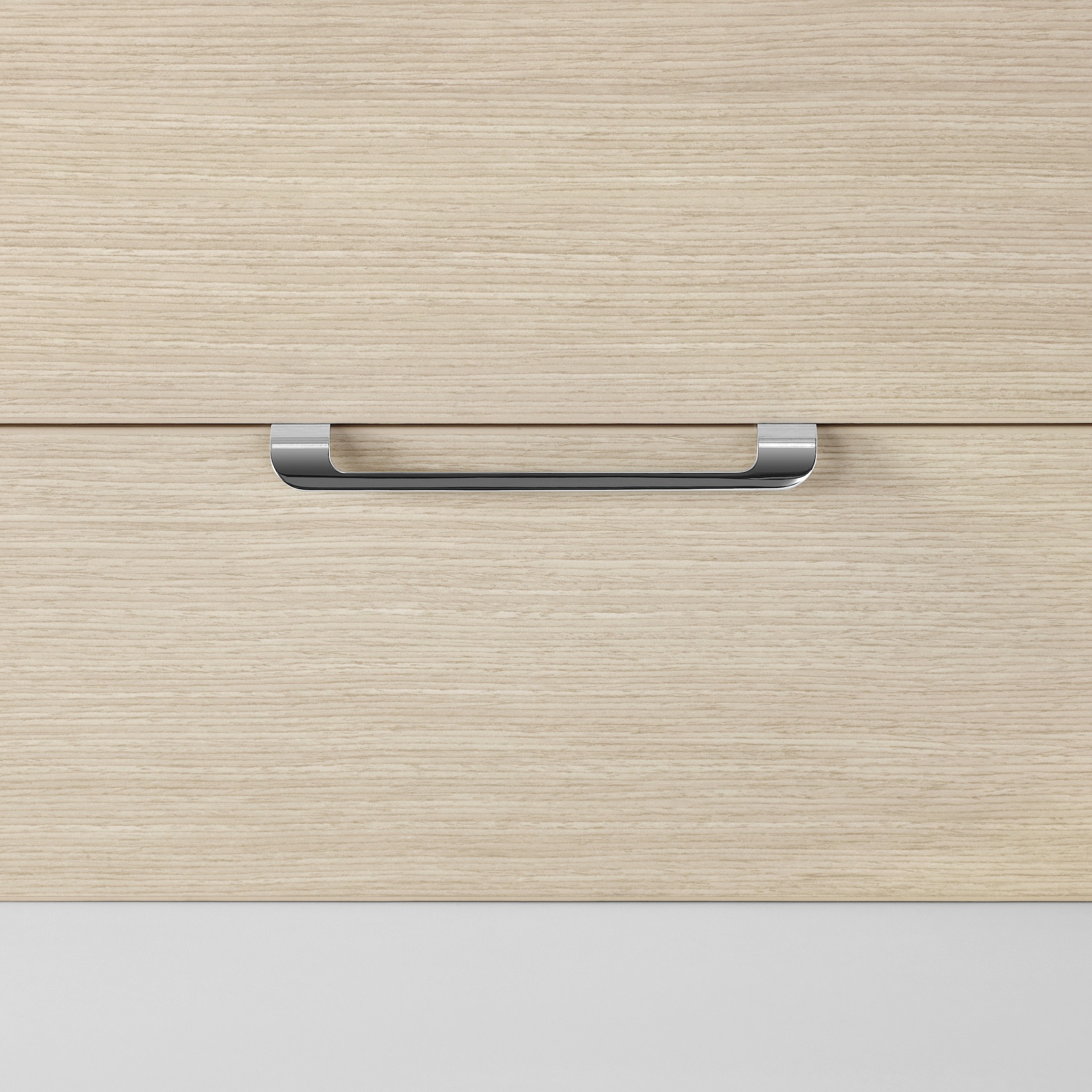 A close-up view of a curved pull on a Mora System casework storage drawer in an ash wood finish.