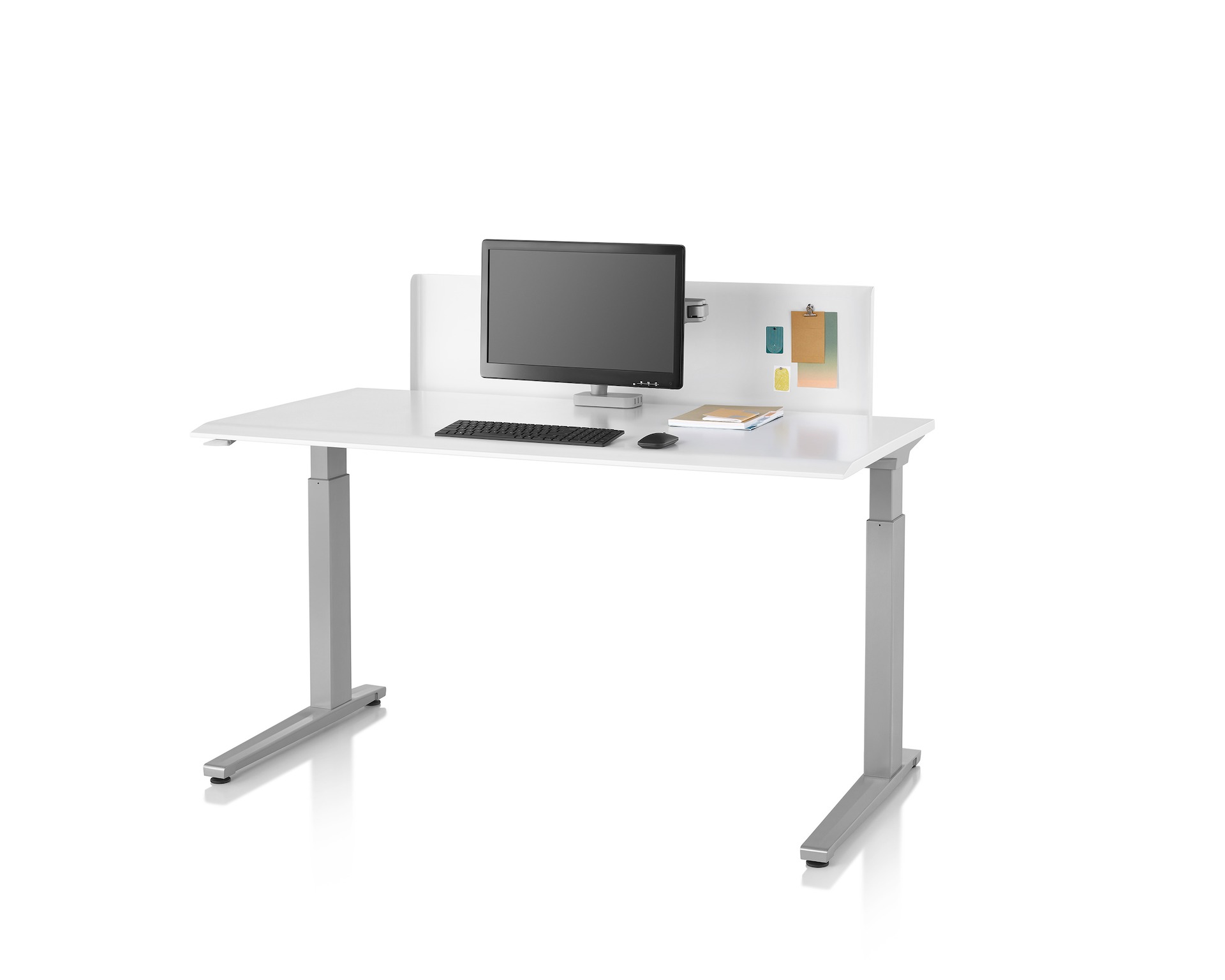 A thin white metal privacy screen installed on a Renew Sit-to-Stand Table that has a white top and silver legs.