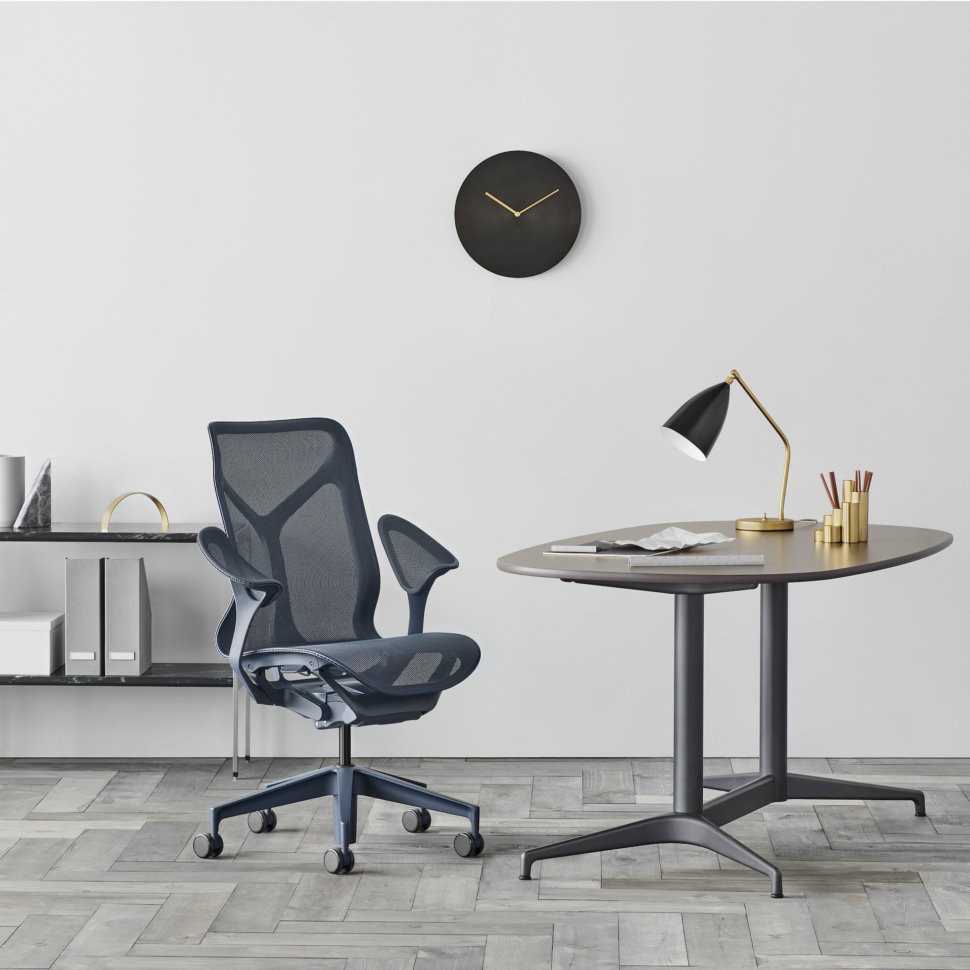 Cosm mid back chair in navy at a desk.