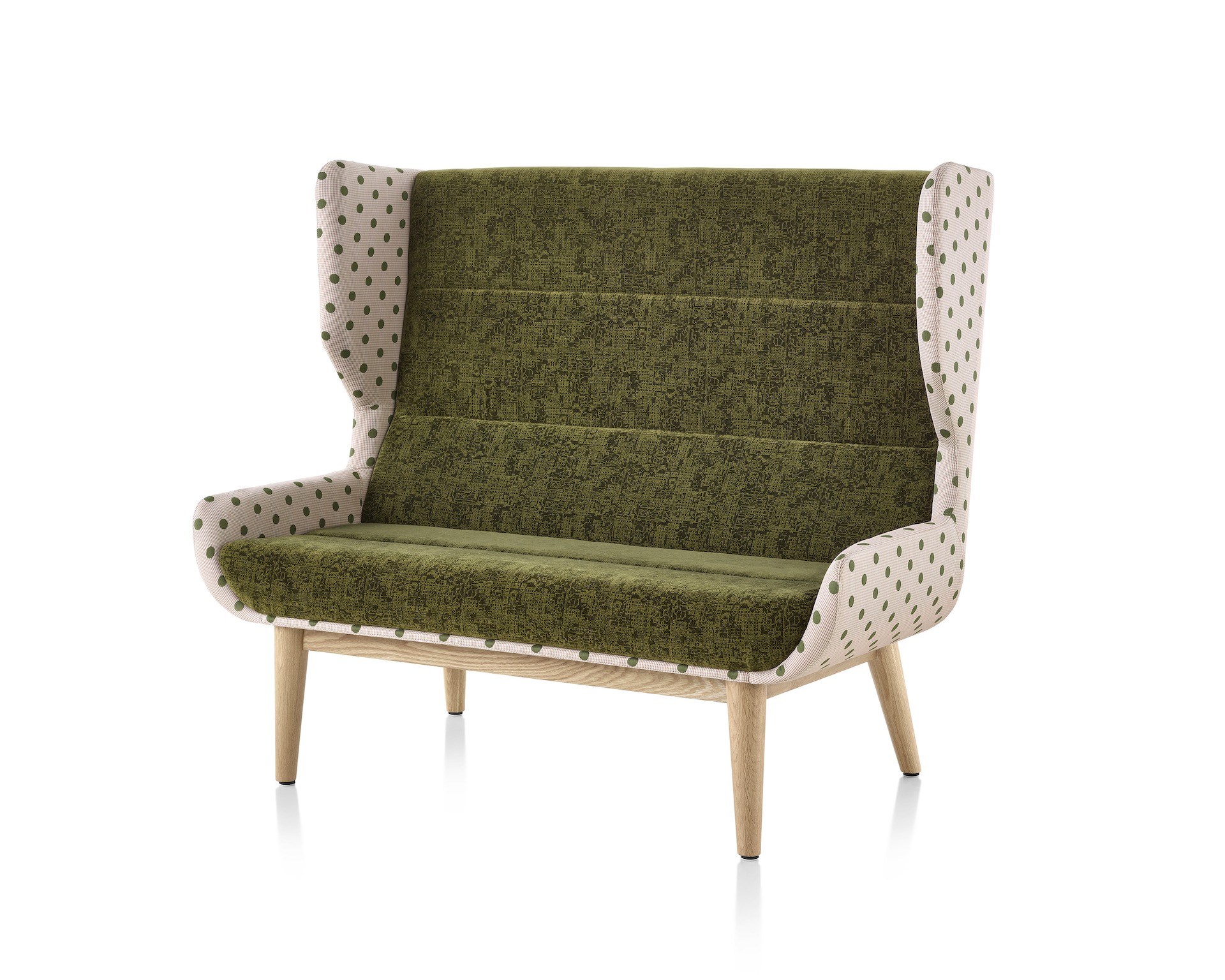 Hush Sofa with a Maharam Paul Smith Lychee Dots outer textile,  a dark green inner textile, and a wood base.