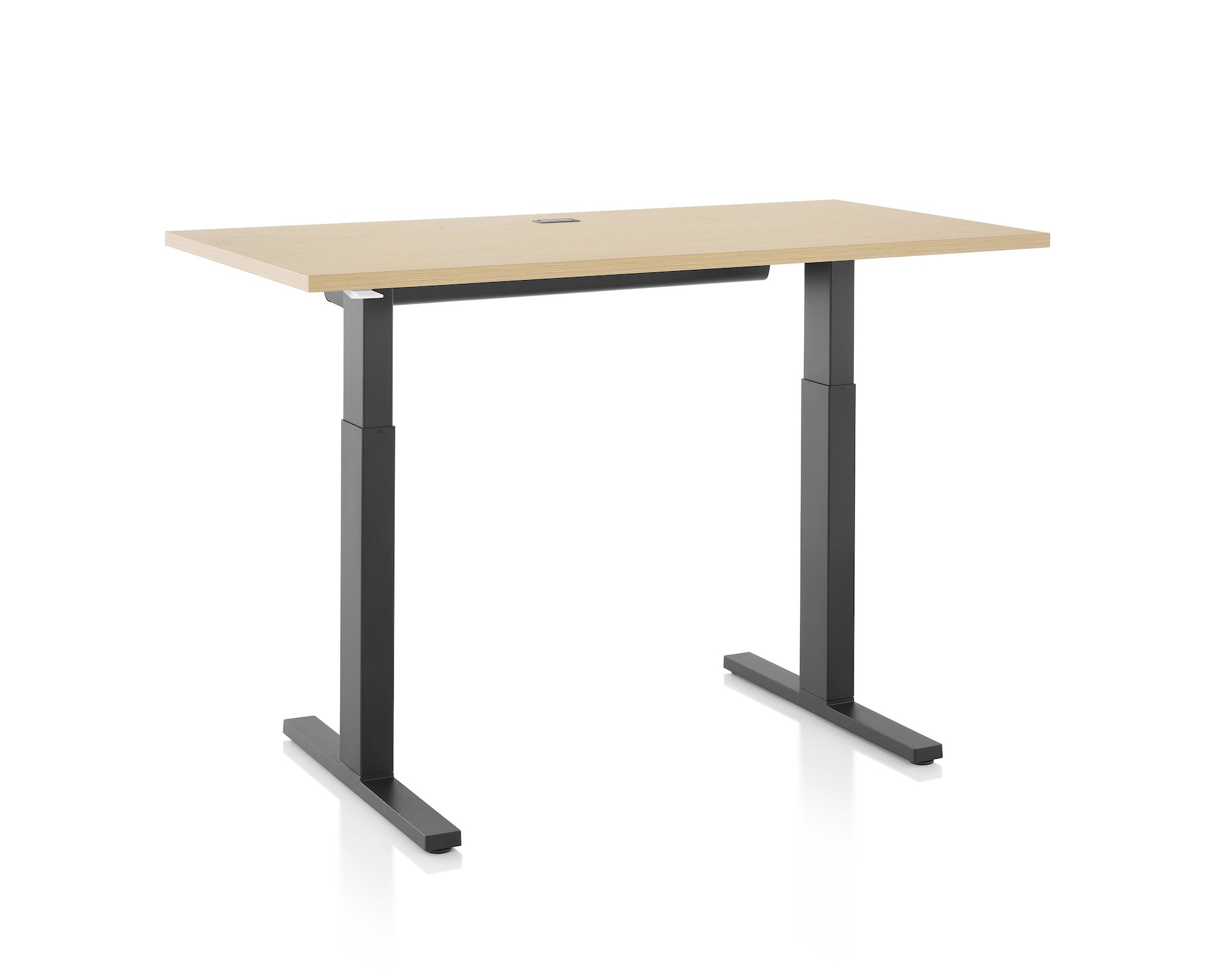 Brown and black Motia sit-to-stand table with cable trough, viewed at an angle. 