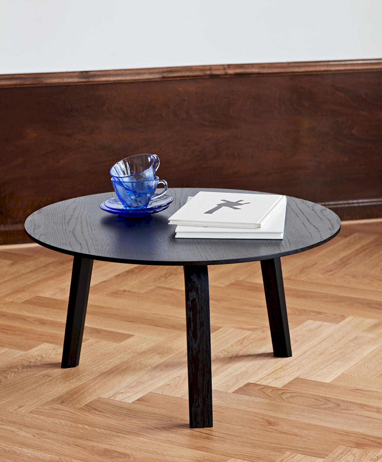 Black Bella Coffee Table standing alone, holding books and dishes.