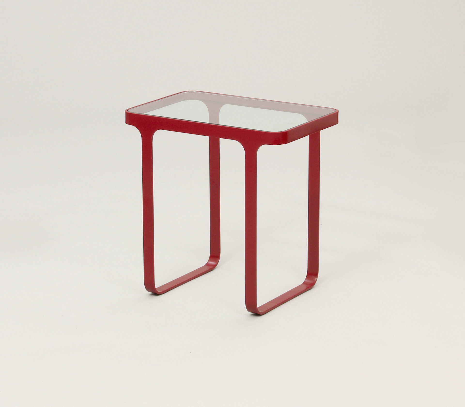 A red naughtone Trace Side Table with glass top.