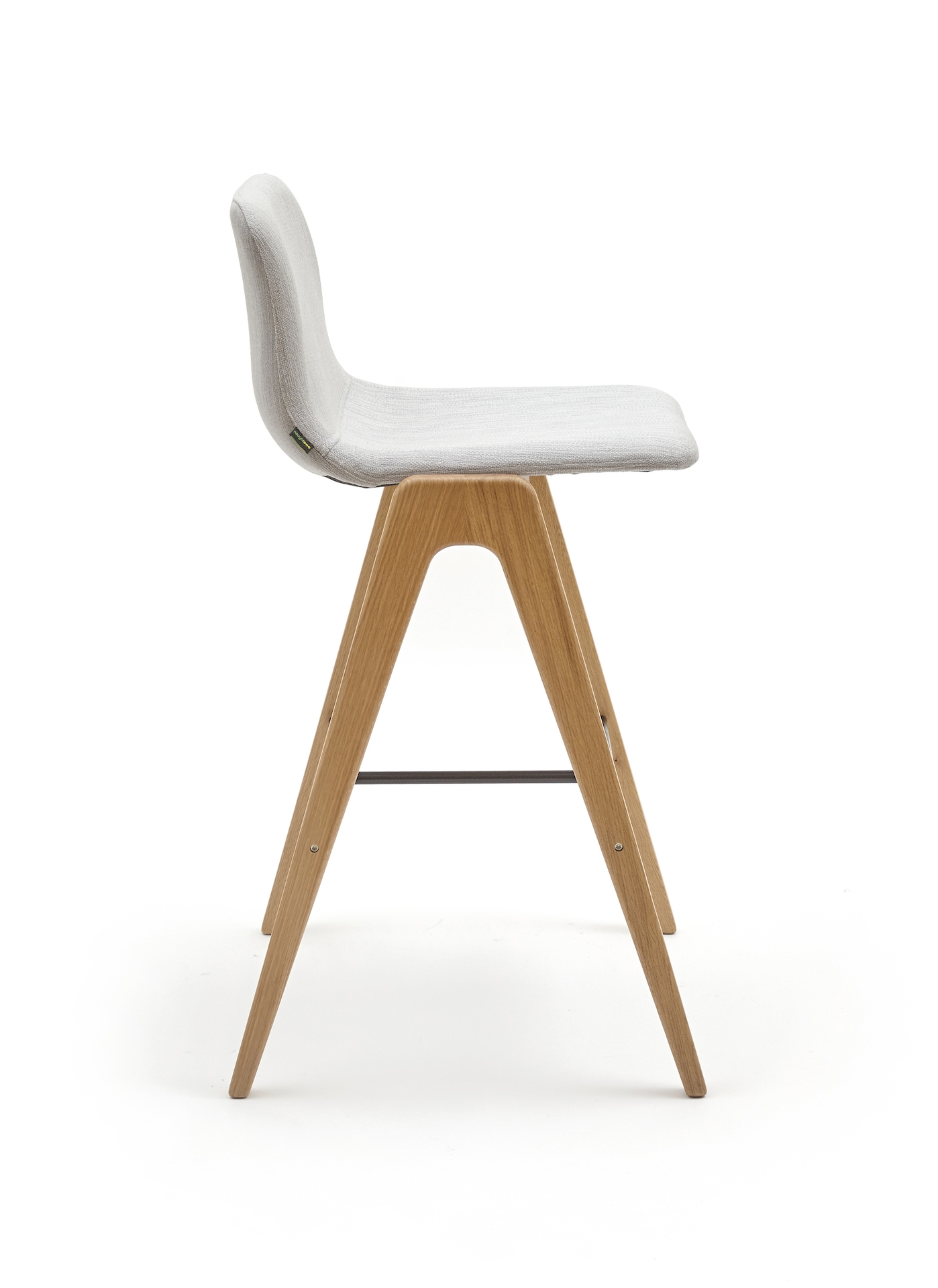 A white upholstered naughtone Viv Wood Stool, viewed from the side.