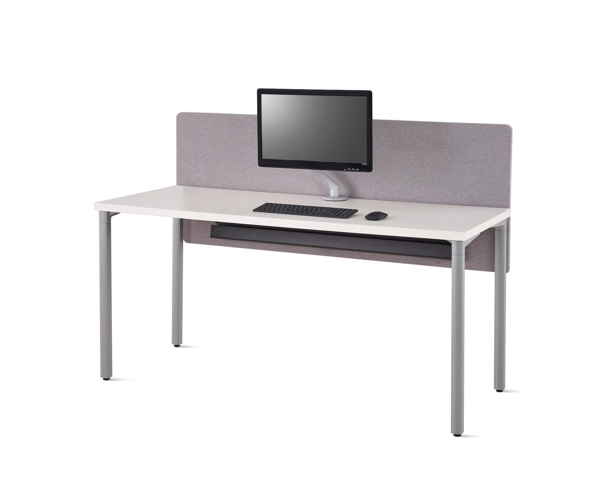 Viewed at an angle, a white Everywhere desk with a gray fabric, surface-attached privacy screen with a screen attached cable trough below the desk.