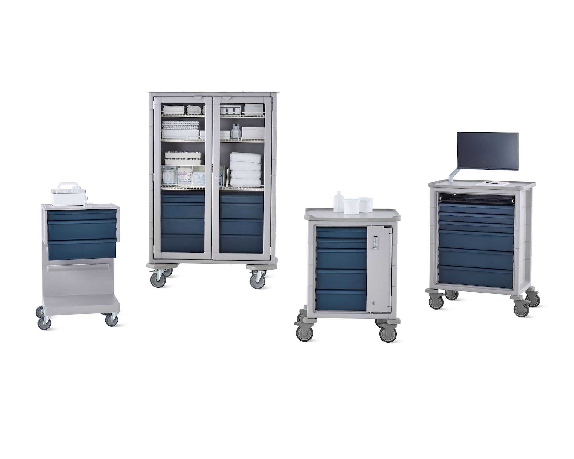 Group of Procedure and Supply Carts including L Cart, double-wide cart, supply cart, and technology cart in light gray body with midnight blue drawers.
