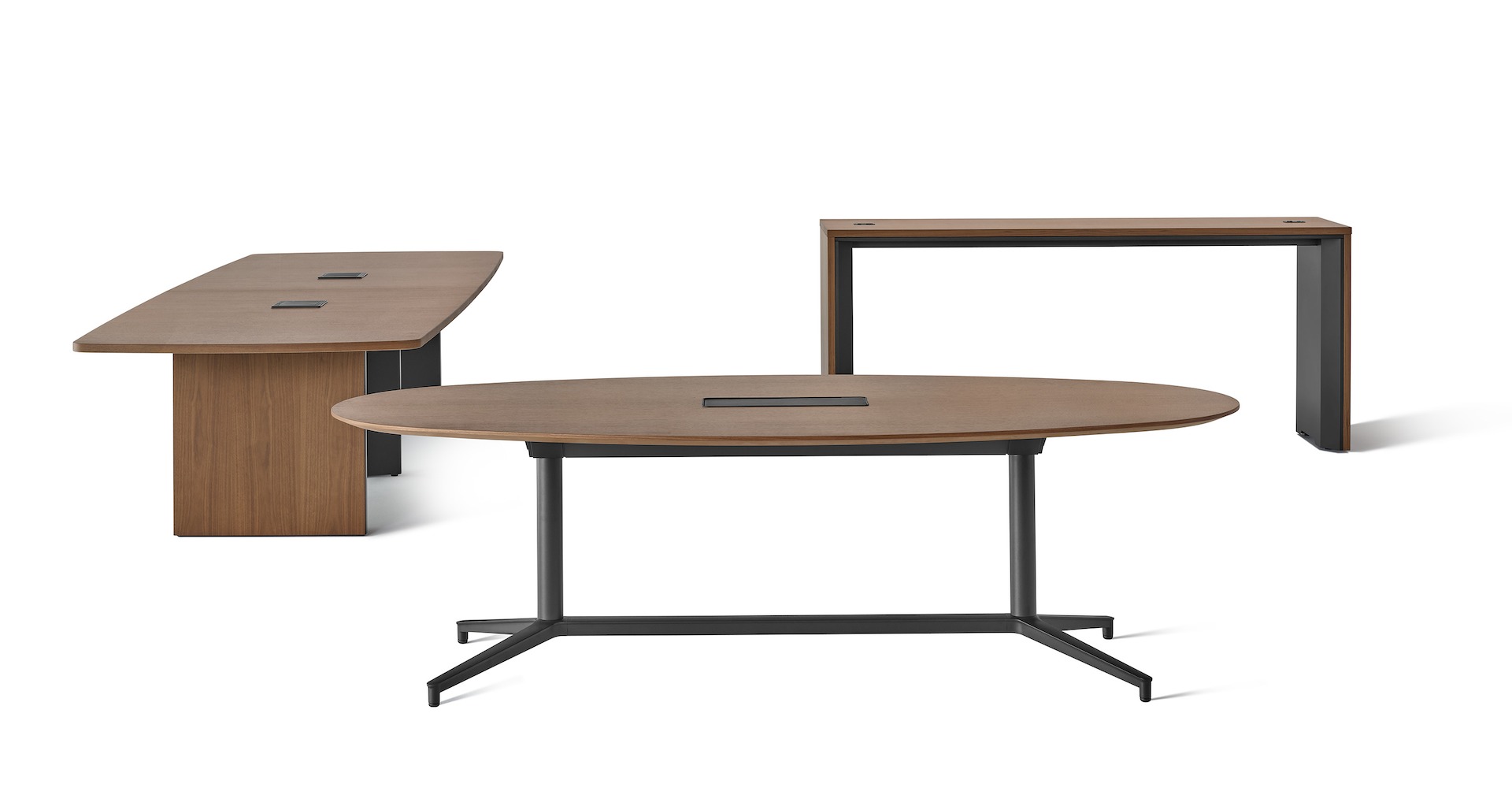 The family of Headway tables including a cabinet base table viewed at an angle, a Y base table, and a communal table in a darker wood tone.