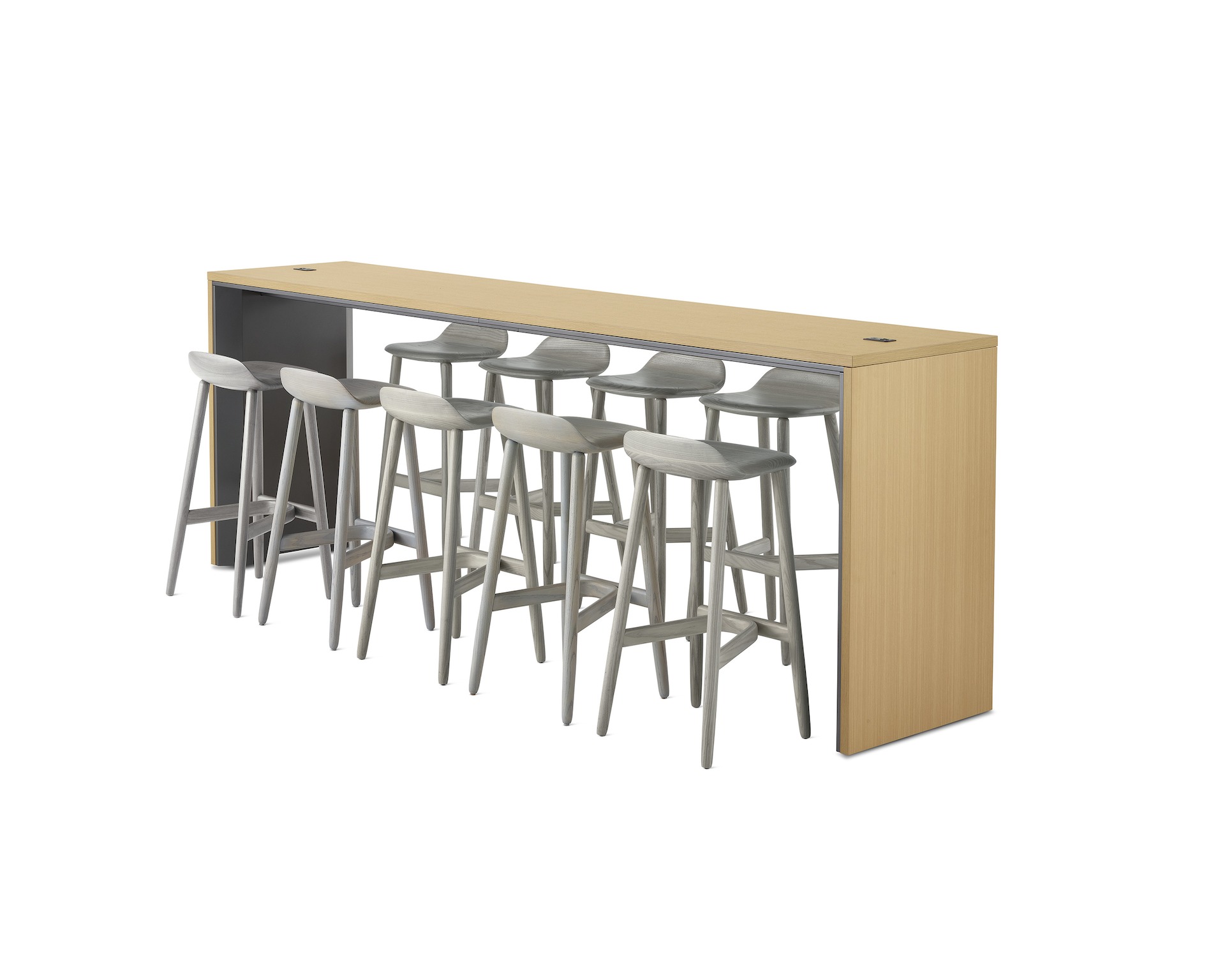 A narrow communal Headway table at standing height surrounded by Crosshatch stools and viewed at a 45-degree angle.