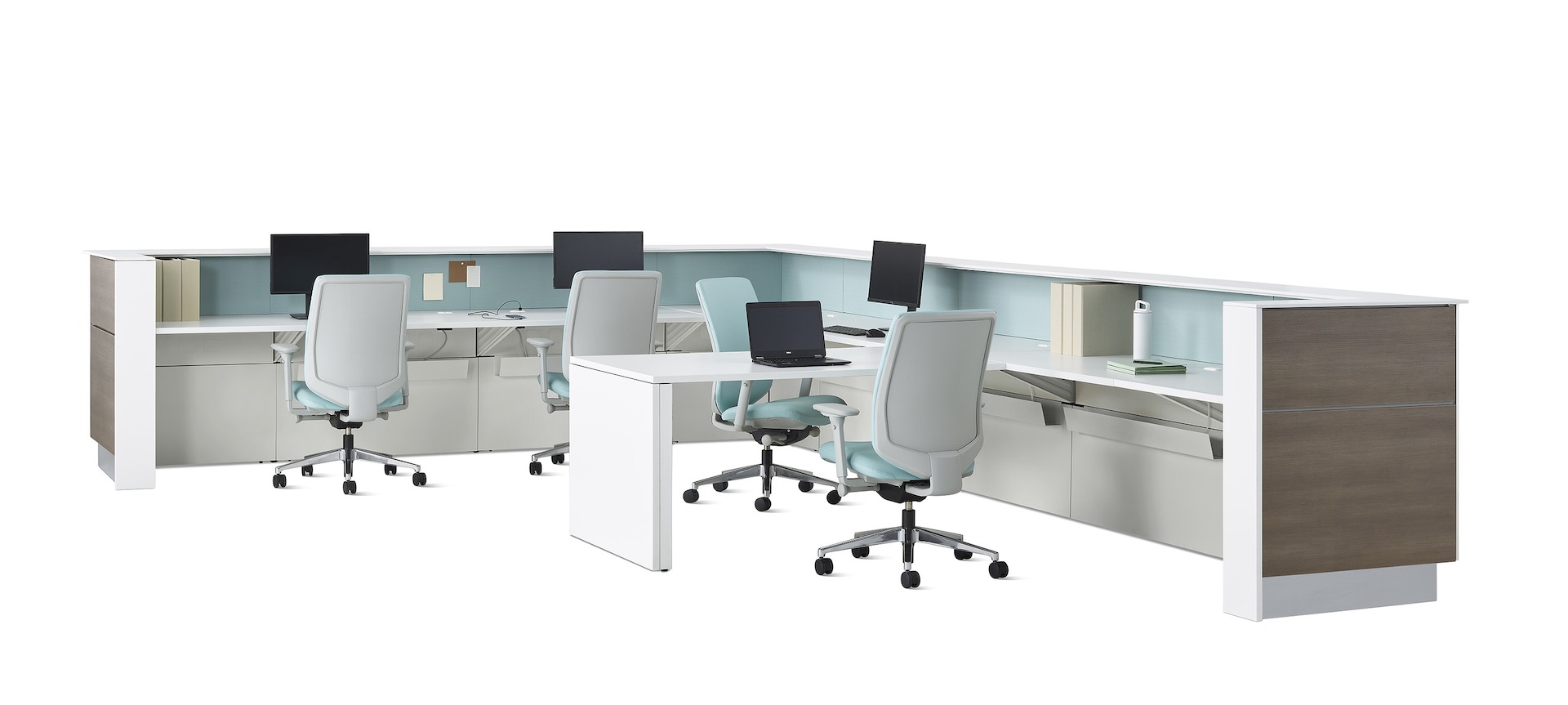 An L-shaped prefab Commend Nurses Station for four with mint Verus chairs, tackable fabric panels and a peninsula worksurface within its interior.