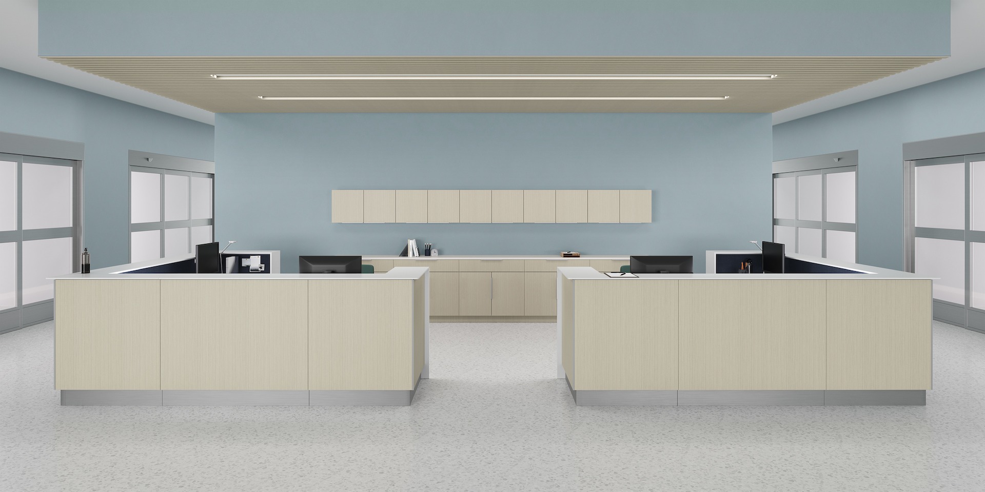 Prefab Commend Nurses Station for four with gray-beige patterned laminate fronts positioned within an inpatient clinic with Mora System...