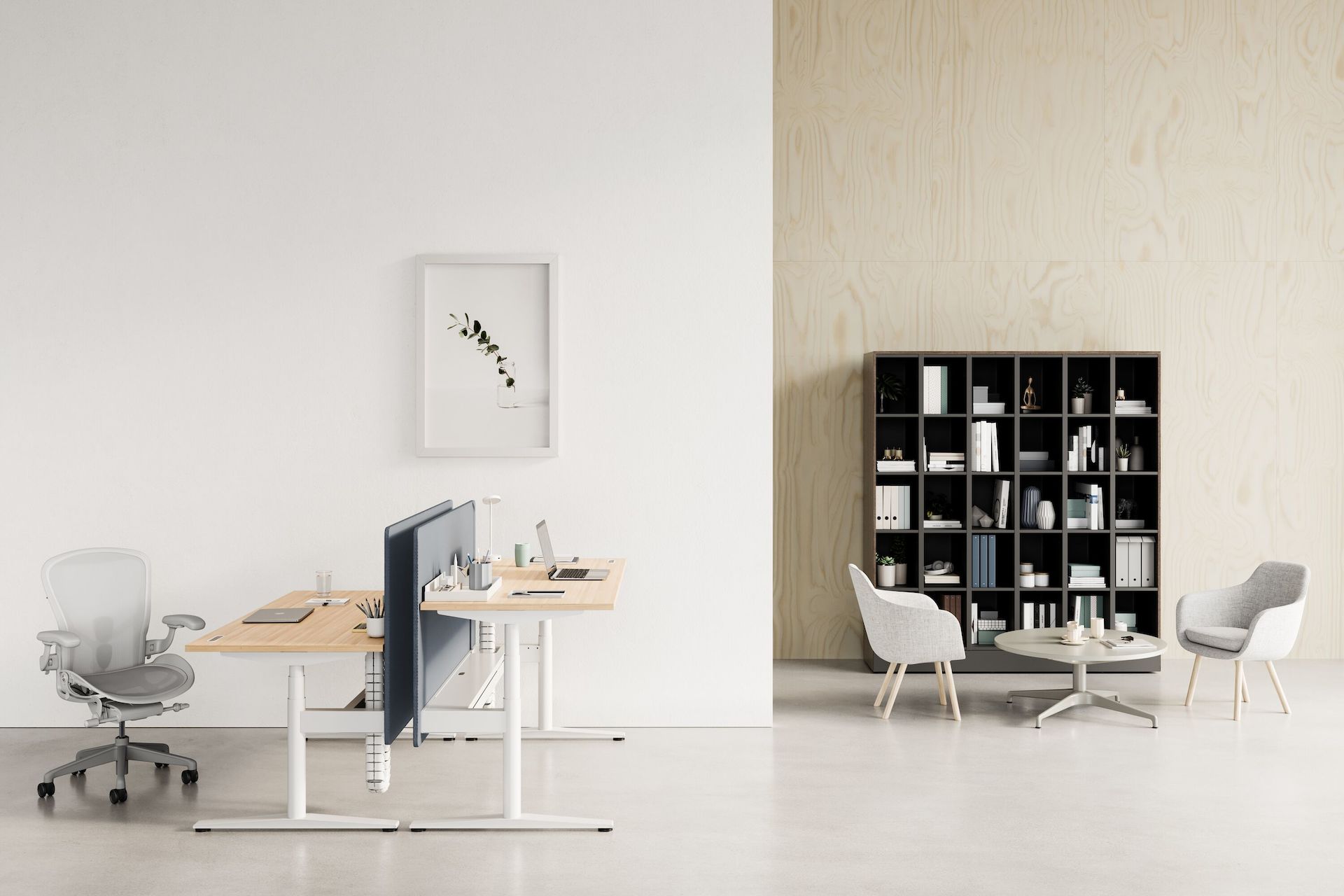 A back to back Ratio desk at both standing and seated heights with a light grey Aeron Chair. Two grey Saiba Chairs with an occasional height Civic Table are shown in front of a Port Storage System.