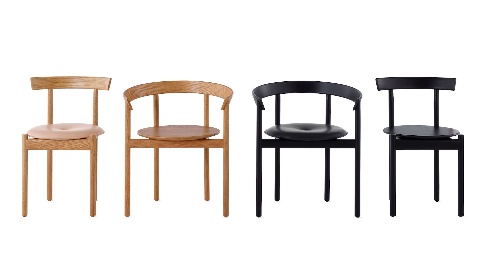 A line up of two oak Comma Chairs and two black Comma Chairs.