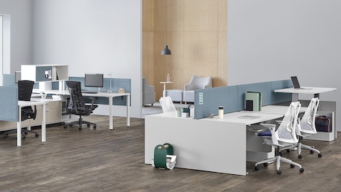 Canvas Channel and Canvas Dock workstations with blue panels, positioned near a lounge area.