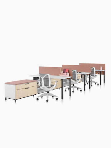 A Canvas Storage workstation with white surfaces, pink screens, and grey Cosm office chairs. Select to go to the Canvas Storage product page.