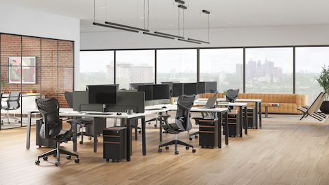 Trac pedestals on casters, Byne Desks, and Mirra 2 Chairs, with a meeting room to the left and lounge seating in the back.