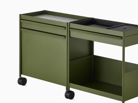 Green OE1 Storage Trolley with drawers, tip-out bin and shelf, viewed from an angle.