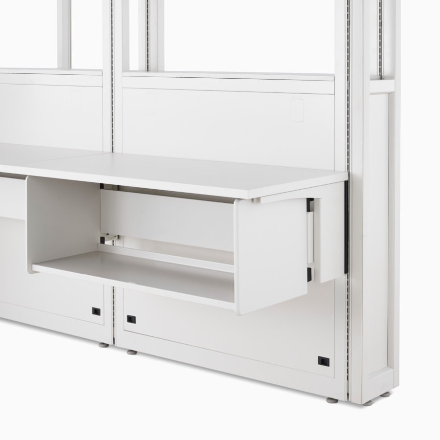 Detail of soft white Co/Struc System frame module, work surface, and B-Style storage shelf hanging on an adapter rail under the surface.