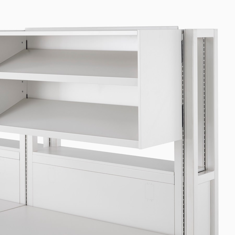 Detail of soft white Co/Struc System frame module with upper storage unit with display shelves.