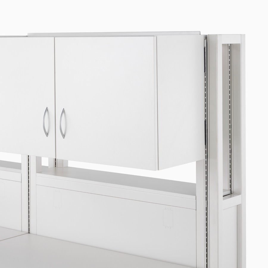 Detail of soft white Co/Struc frame module with double-door closed upper storage unit.