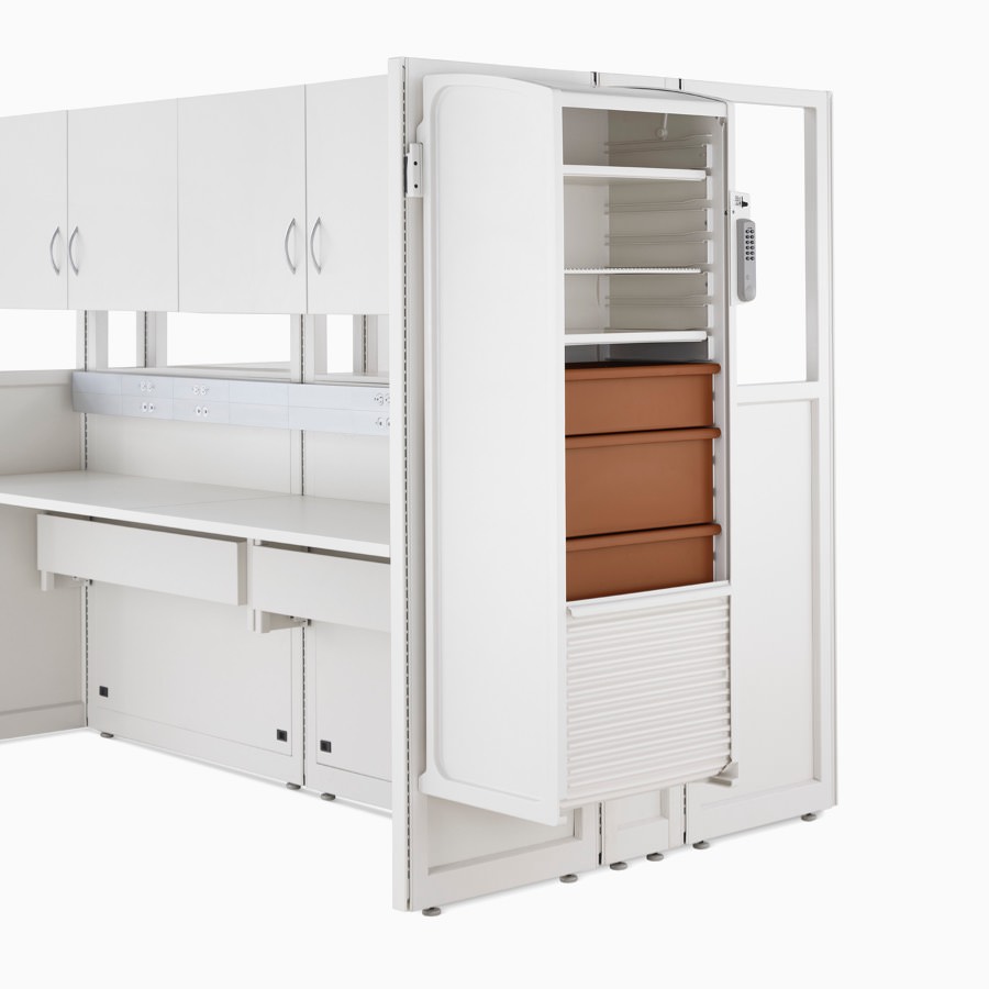 Detail of soft white Co/Struc System frame module with hanging locker with terra cotta drawers.
