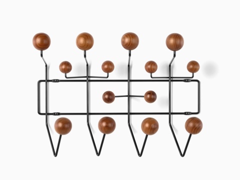 An Eames Hang-It-All storage rack, featuring a black wire frame and wood knobs in a medium finish.