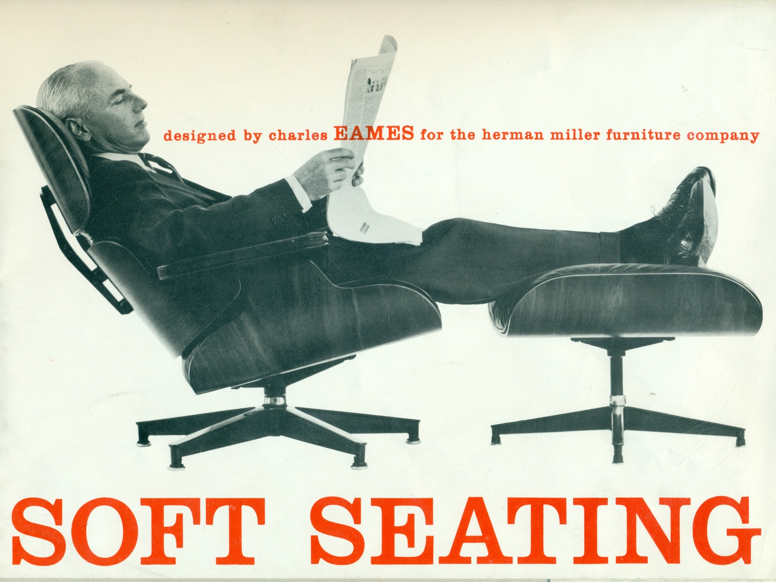Vintage black-and-white photo of a man reading a newspaper while reclining in an Eames Lounge Chair and Ottoman. 