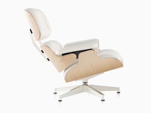 Profile view of a white leather Eames Lounge Chair with a white ash veneer shell.  
