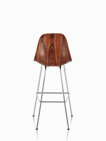 Eames Molded Wood Stool with a dark finish and silver legs, viewed from the rear. 