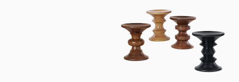 四张 Eames 转动式凳子，形状各异，采用乌木灰、白橡木和胡桃木饰面。