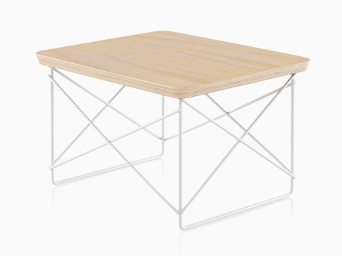 An angled view of an Eames Wire Base Low Table with a white ash veneer top. 
