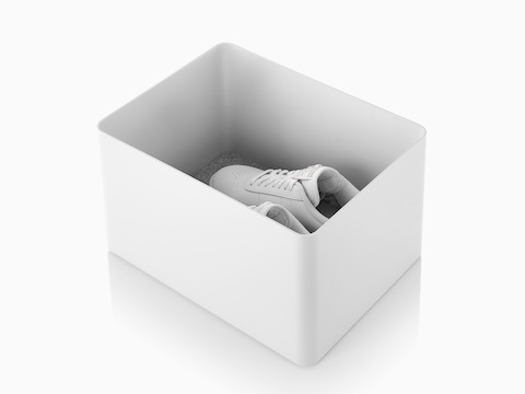 A white Formwork Tall Bin containing running shoes.