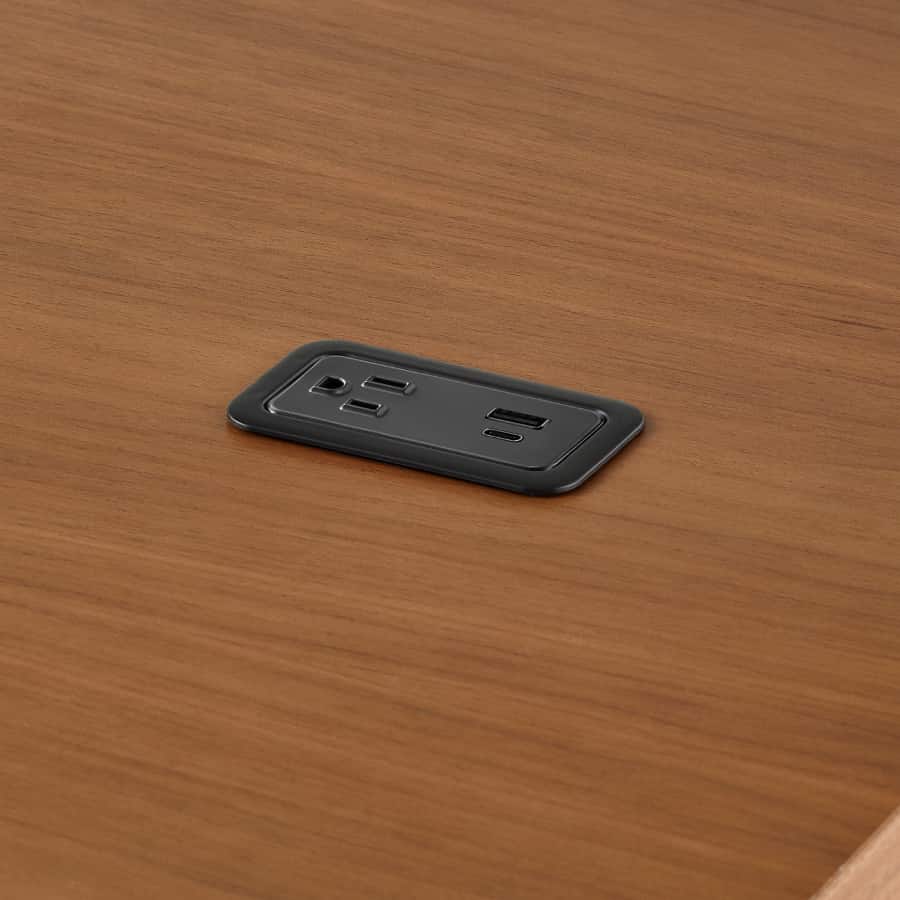 A close-up view of a Logic Mini installed in the surface of a Headway communal table.