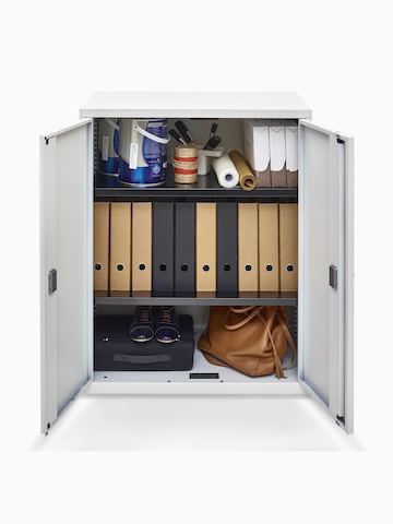 Open hinged doors on a Value storage cupboard reveal binders and personal items inside.